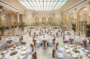 a large banquet hall with tables and chairs at The Waldorf Hilton in London