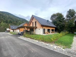 a large wooden house on the side of a road at Mountain Chalet Arnica in Sankt Lorenzen ob Murau