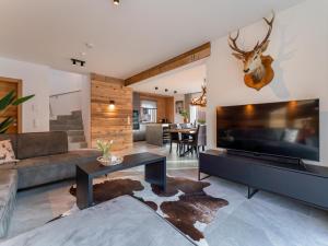 a living room with a large flat screen tv at Mountain Chalet Berg-Glück in Sankt Lorenzen ob Murau