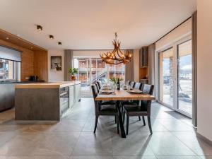 a kitchen with a table and chairs and a chandelier at Mountain Chalet Berg-Glück in Sankt Lorenzen ob Murau
