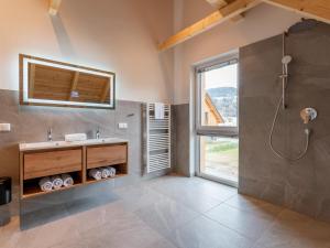 a bathroom with a sink and a shower at Mountain Chalet Berg-Glück in Sankt Lorenzen ob Murau +50 photos