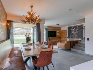 a dining room with a table and chairs and a chandelier at Bergzicht in Sankt Lorenzen ob Murau