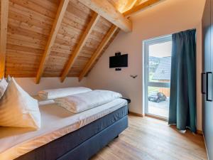 a bedroom with a bed and a large window at Bergzicht in Sankt Lorenzen ob Murau