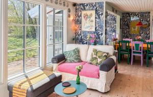 a living room with a couch and a table at Amazing Home In Græsted With Wifi in Græsted