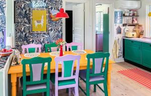 a kitchen with a table with colorful chairs at Amazing Home In Græsted With Wifi in Græsted