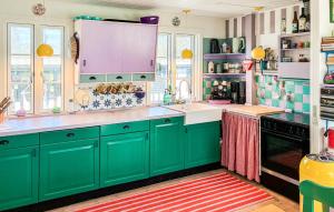 a kitchen with green cabinets and a sink at Amazing Home In Græsted With Wifi in Græsted