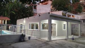 a house under construction with a pool at Acomodações Souza in Ilhabela