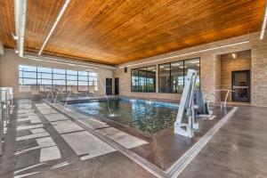 a swimming pool in a building with a large ceiling at Country Inn & Suites by Radisson, Amarillo Central in Amarillo