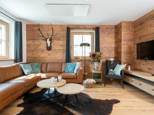 a living room with a couch and a table at Haus Liene in Donnersbachwald