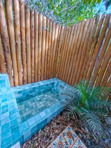 a backyard with a wooden fence and a small pool at Orixás Residence -Casa Yemanja Morro in Cairu +5 photos