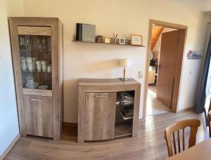 a room with a wooden cabinet with a lamp and a table at Wohnung mit Balkon im Schwarzwald in Seebach
