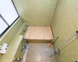 a shower with a tiled floor in a bathroom at Nikko TEN Stay in Nikko +35 photos