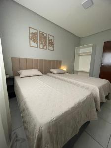 a bedroom with two beds with white sheets at Apto do xavier III in Petrolina
