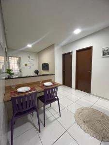 a kitchen with a wooden table and two chairs at Apto do xavier III in Petrolina