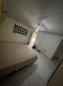 a bedroom with a bed and a window at Casa Shekinah in Araruama +16 photos
