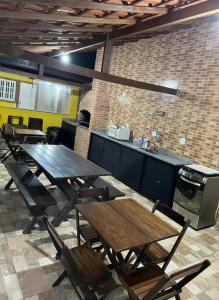 a restaurant with tables and chairs in a room at Casa Shekinah in Araruama