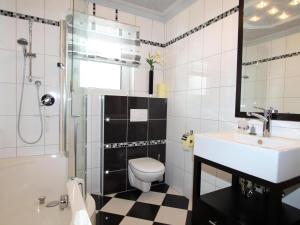 a bathroom with a sink and a toilet and a shower at Mangartblick in Arriach