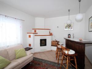 a living room with a couch and a fireplace at Mangartblick in Arriach