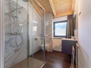 a bathroom with a shower and a toilet and a window at Obermöschach 6 in Obermöschach +74 photos