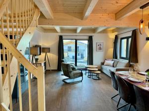 a living room with wooden ceilings and a staircase at Obermöschach 6 in Obermöschach
