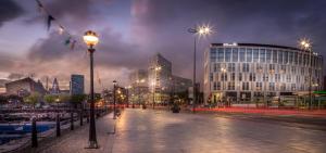 a city street at night with buildings and street lights at Hilton Liverpool City Centre in Liverpool