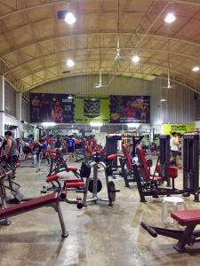 a gym with a bunch of exercise equipment in it at Apinsaya House in Ban Pa Sang (1)