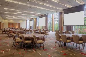 a conference room with tables and chairs and large windows at Hilton Liverpool City Centre in Liverpool