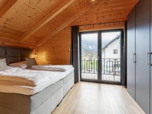 a bedroom with two beds and a large window at Rattendorf 1A in Rattendorf