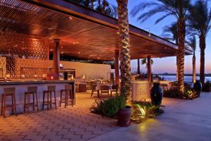 an outdoor bar with a view of the ocean at Hilton Luxor Resort & Spa in Luxor