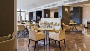 a restaurant with tables and chairs in a room at DoubleTree by Hilton Luxembourg in Luxembourg +109 photos
