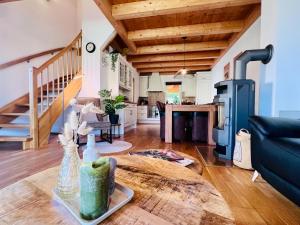 a living room with a table and a stove at Casa Nostra in Kötschach