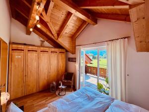a bedroom with a bed and a large window at Casa Nostra in Kötschach +36 photos
