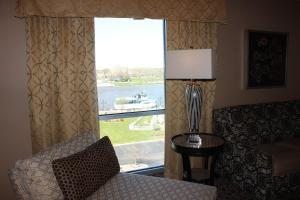 a room with a chair and a window with a view at DoubleTree by Hilton Bay City - Riverfront in Bay City