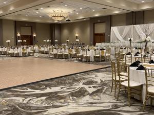 a banquet hall with tables and chairs in a room at DoubleTree by Hilton Bay City - Riverfront in Bay City +56 photos
