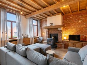 a living room with a couch and a fireplace at De Marckhoeve in Merksplas