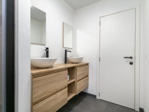 a bathroom with two sinks and a mirror at De Marckhoeve in Merksplas +53 photos