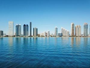 a view of a city from across the water at DoubleTree by Hilton Ocean Point Resort - North Miami Beach in Miami Beach
