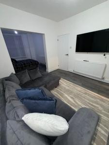 a living room with a couch and a flat screen tv at City Home in Liverpool