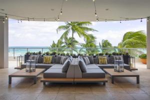 a living room with a couch and a view of the ocean at DoubleTree by Hilton Ocean Point Resort - North Miami Beach in Miami Beach