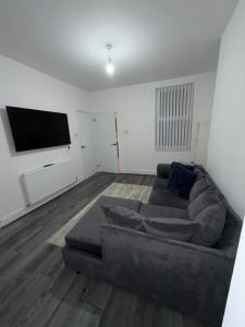 a living room with a couch and a flat screen tv at City Home in Liverpool