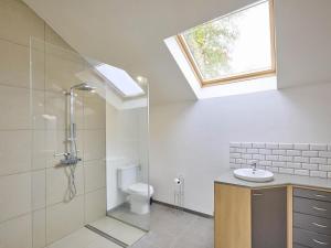 a bathroom with a toilet and a sink and a skylight at Quanto A in Geetbets +30 photos