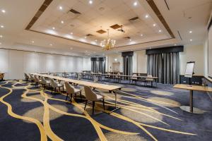 a large conference room with tables and chairs at Hilton Northampton Hotel in Northampton