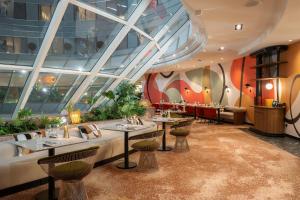 a restaurant with tables and chairs in a building at Hilton Paris La Défense in Puteaux +70 photos