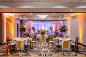 a ballroom with tables and chairs in a room at Embassy Suites by Hilton Portland Airport in Portland +44 photos