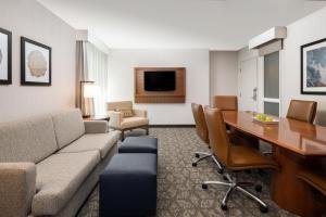 a living room with a couch and a table at Embassy Suites by Hilton Portland Airport in Portland