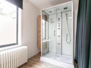 a shower with a glass door in a bathroom at Maison Clement in Maasmechelen +52 photos