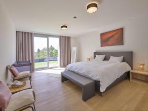 a bedroom with a bed and a couch and a chair at Maison Oscar in Tongeren +63 photos