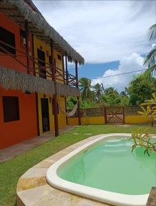 a swimming pool in front of a house at Flatmoitas in Amontada