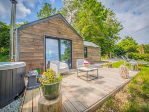 a backyard with a wooden deck with a tiny house at Be Chalet in Ferrières
