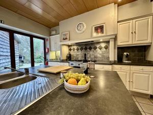 a kitchen with a bowl of fruit on a counter at Le GitAnne in Sourbrodt